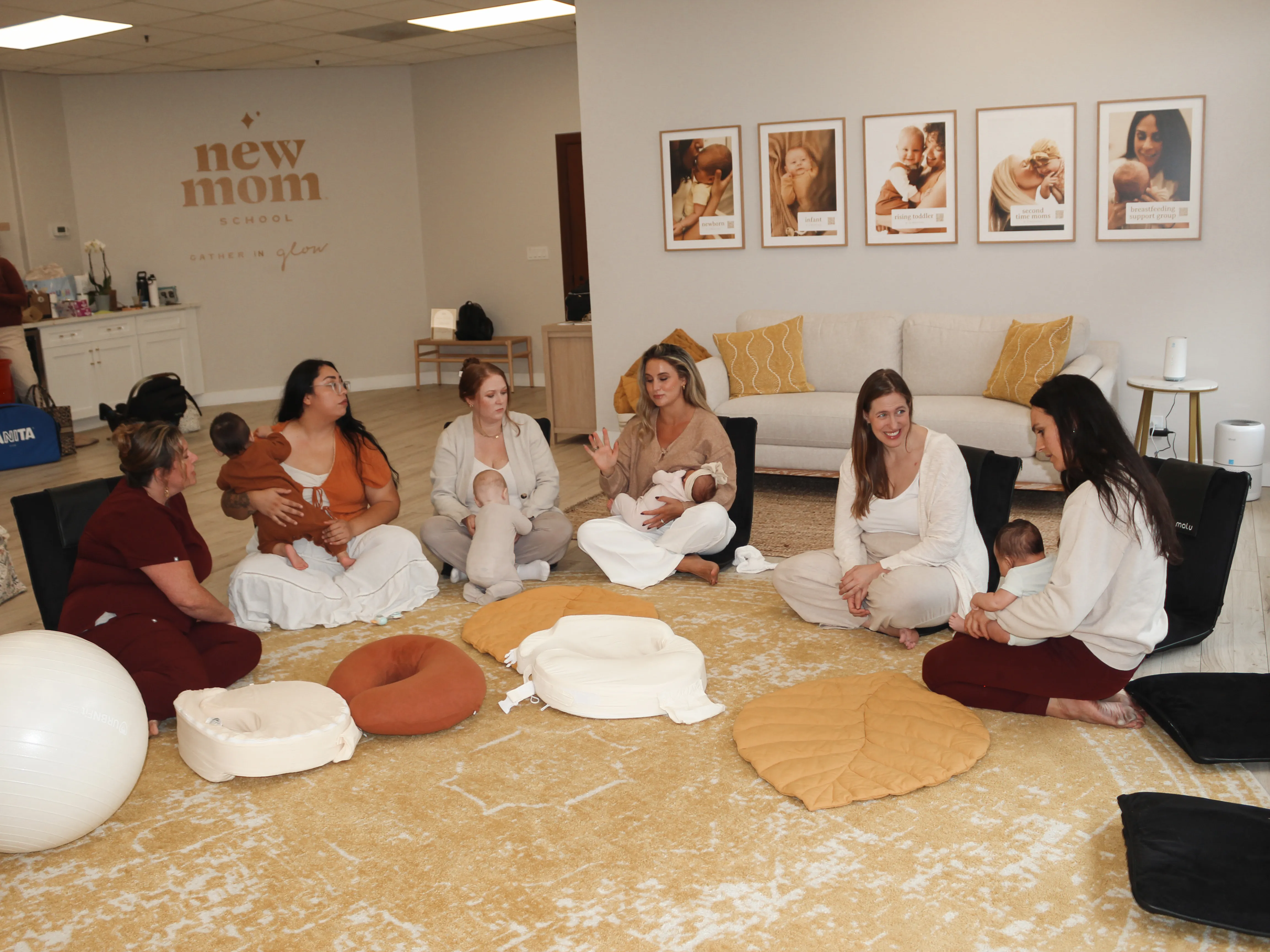 Group of new moms with newborns in a lactation support circle session